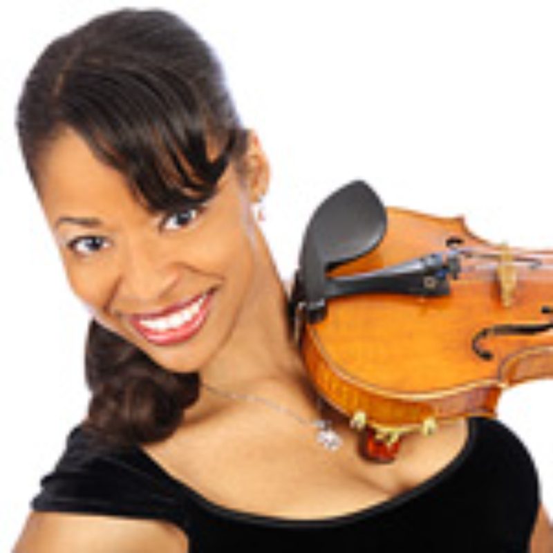 Smiling woman holding a violin.