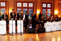 Jazz band performing in elegant indoor setting.