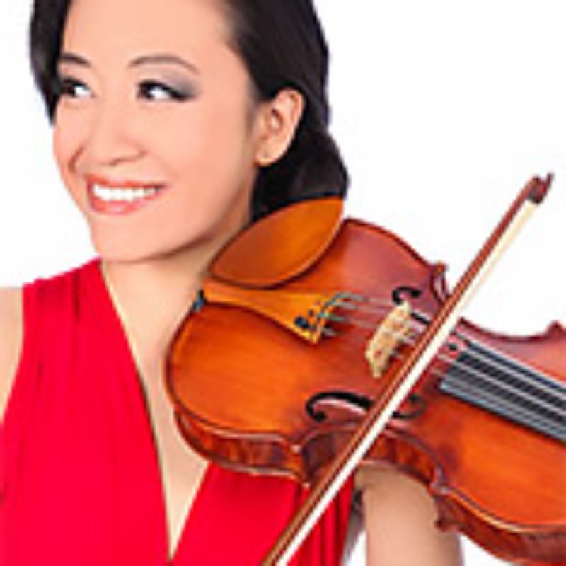 Smiling woman holding a violin.