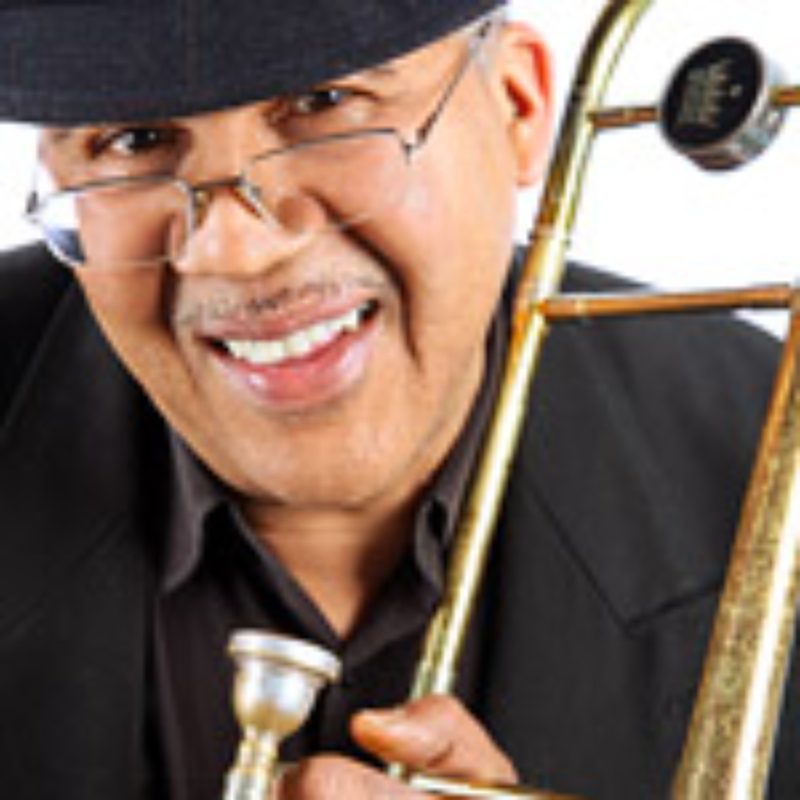 Man smiling and holding a trombone.