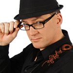Man in hat and glasses, adjusting frame.