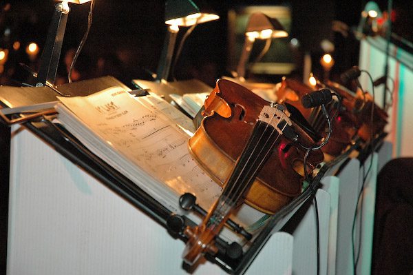 Violin on music stand with sheet music.