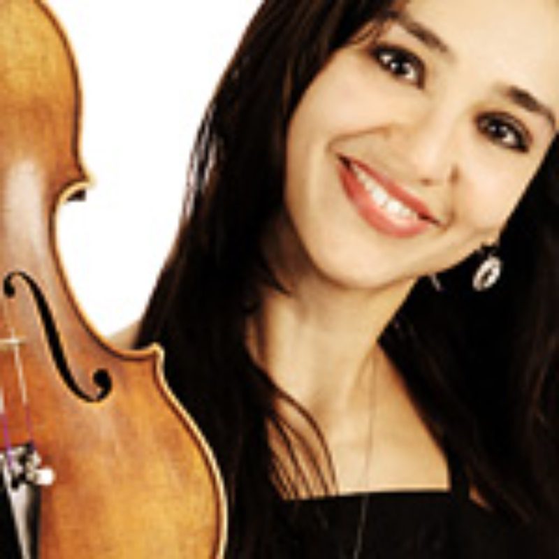 Smiling woman with violin against white background.